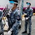 Members of the Philippine Coast Guard wearing protective masks hold their weapons with gloves outside a passenger vessel turned into a temporary quarantine facility for Filipino seafarers to contain the coronavirus disease (COVID-19) in Manila, Philippine