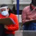 Young people wearing protective face masks and face shields maintain social distancing as a measure to contain the spread of the coronavirus disease (COVID-19) as they take the entrance exam for Mexico's National Autonomous University in the stands of Uni