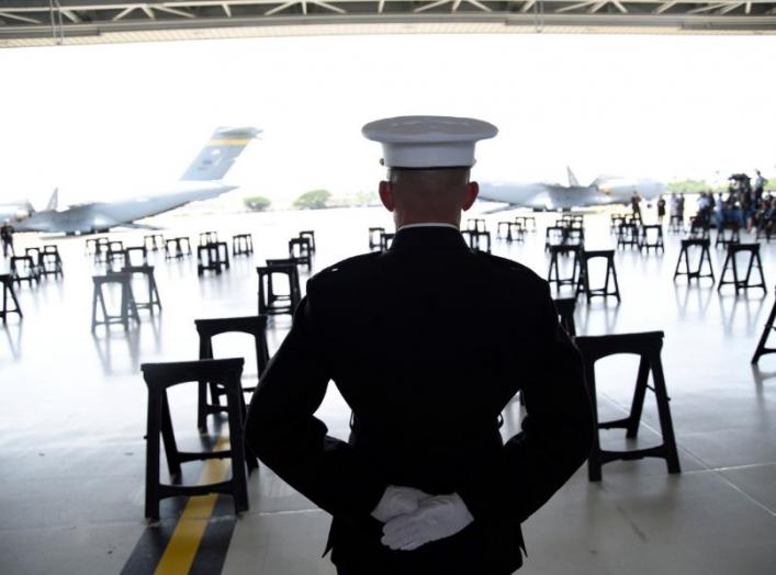 A U.S. Marine stands as caskets containing the remains of American servicemen from the Korean War handed over by North Korea arrive at Joint Base Pearl Harbor-Hickam in Honolulu, Hawaii, U.S., August 1, 2018. REUTERS/Hugh Gentry