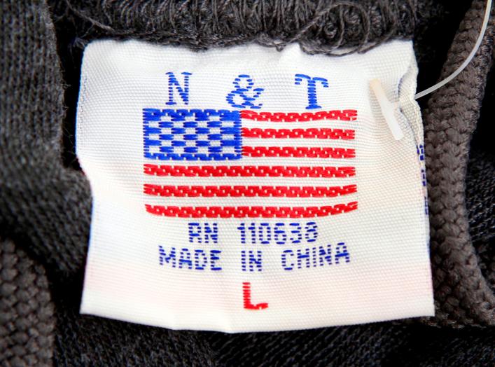 The label of a Washington D.C. sweatshirt bears a U.S. flag but says "Made in China" at a souvenir stand in Washington, DC, U.S., January 14, 2011. REUTERS/Kevin Lamarque/File Photo